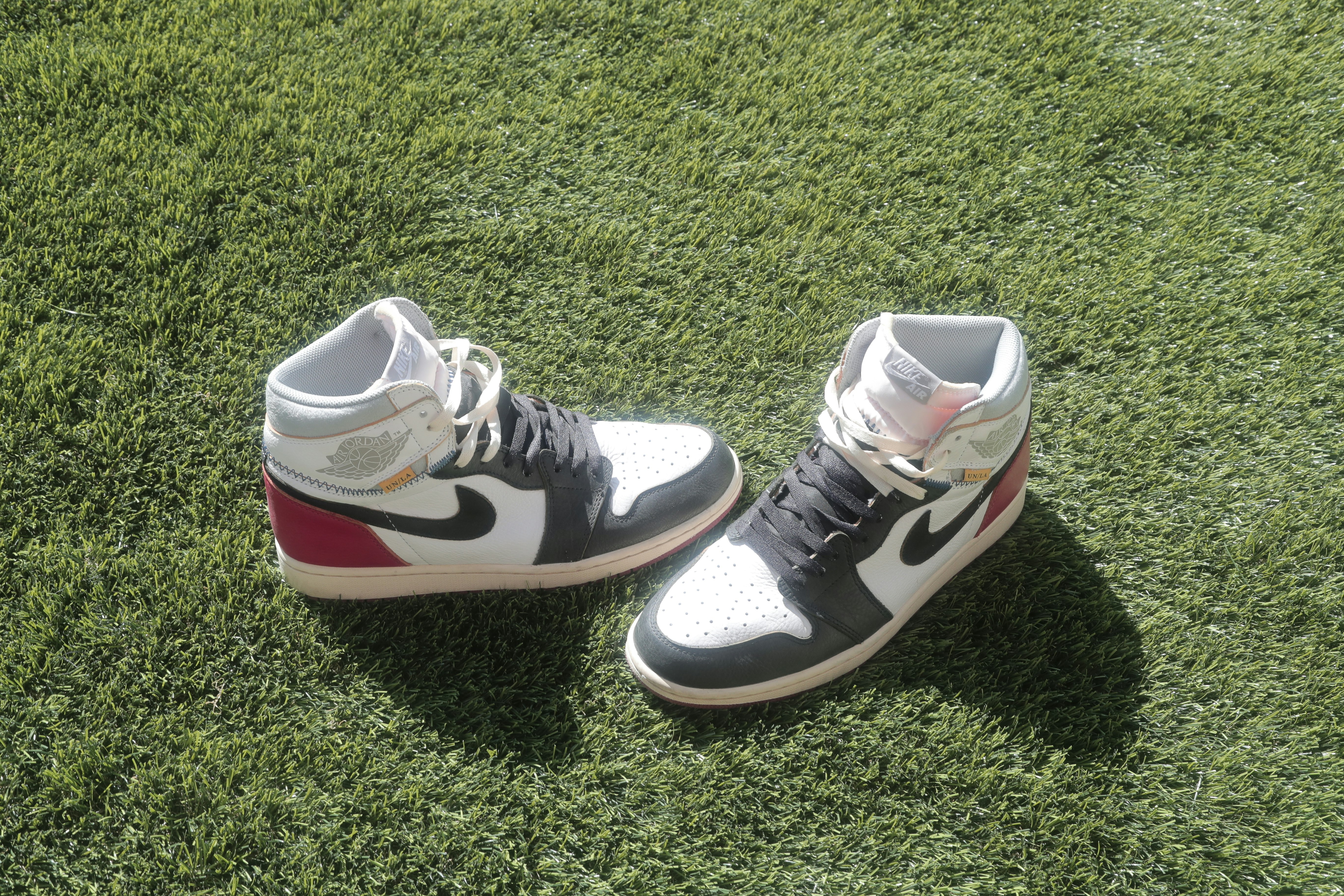 black and white nike high top sneakers on green grass